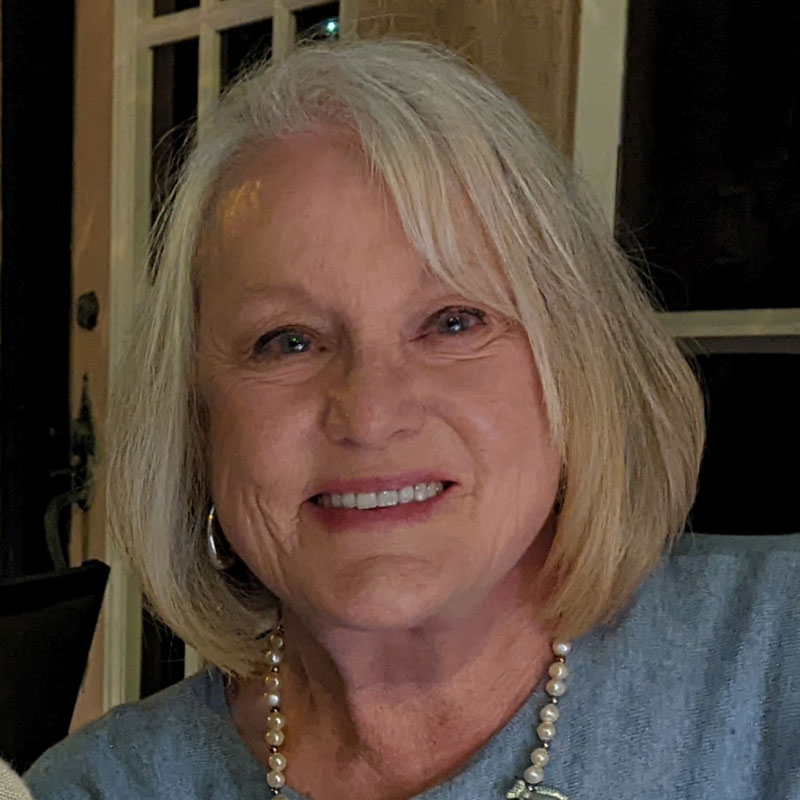Blond woman smiling.