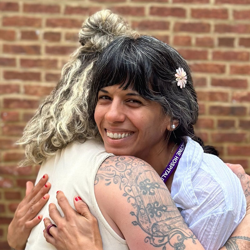 Two ladies hugging.